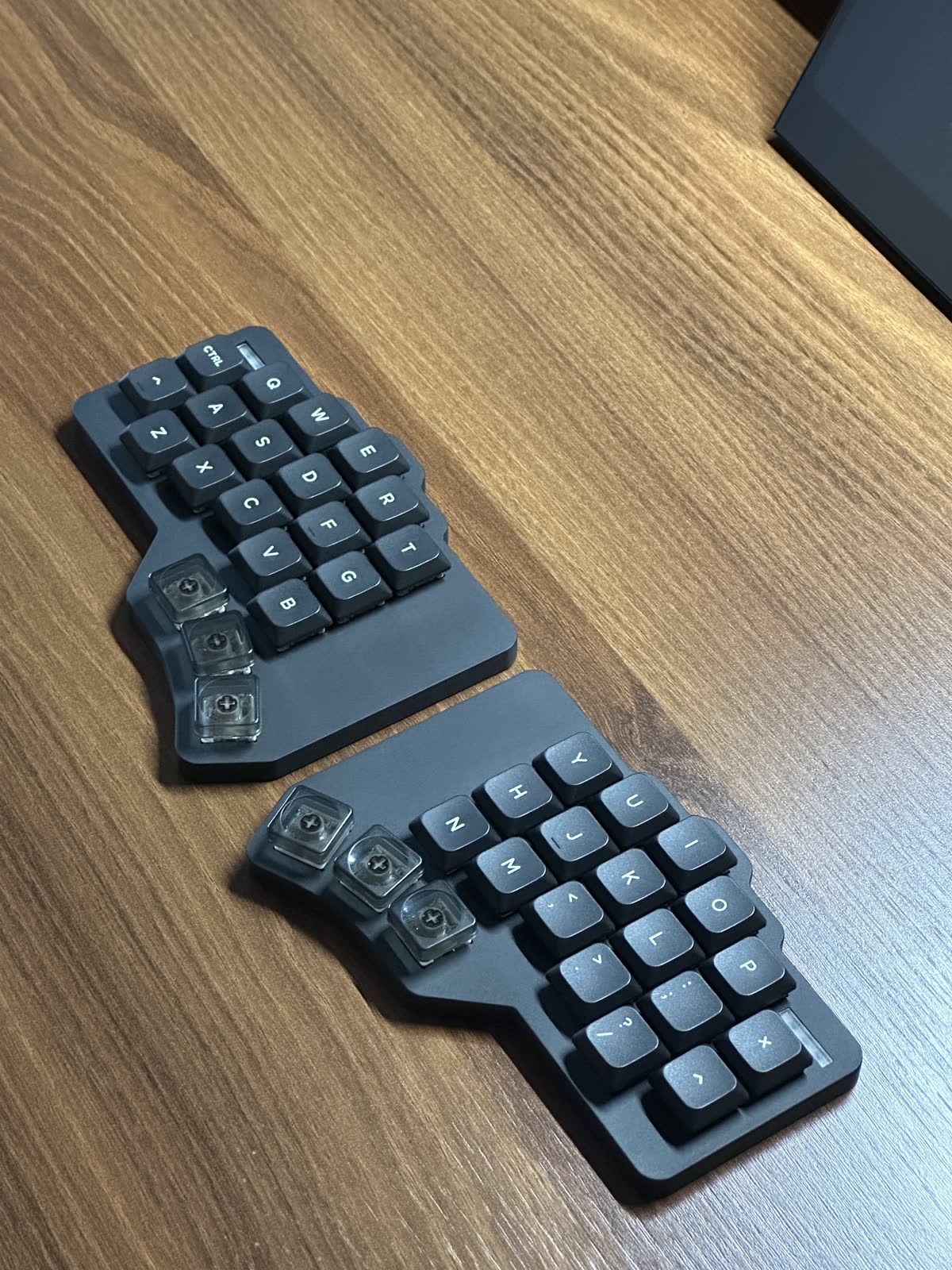 Both keyboard halves arranged on a wooden desk